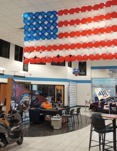 8 by 5 foot balloon sculpture hanging from ceiling in dealership showroom